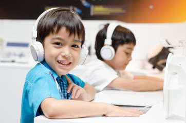 Little boy with headset in classroom