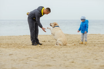 family with dog on the beach