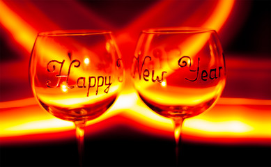 Happy new year`s eve wine glass against fire