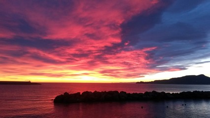 Fototapeta na wymiar Red fired Sunset over Portofino mount