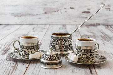 Fototapeta na wymiar Traditional Turkish Coffee cups and pot on white table background
