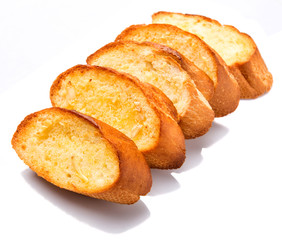 Fototapeta premium Homemade garlic bread of French baguette over white background