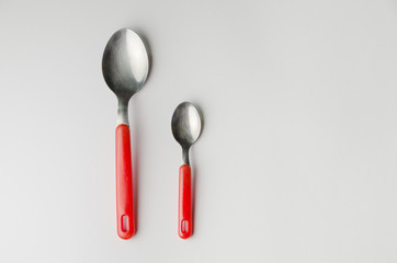 one large and one small spoon together