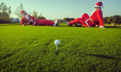 Two Santas on the golf course