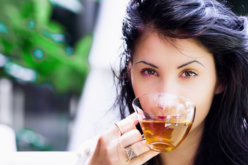 Young woman portrait drinking tea