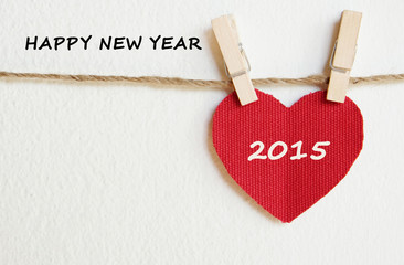 Red fabric heart with happy new year 2015 word background