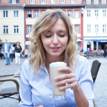 Frau mit blonden Locken liebt Kaffee Latte
