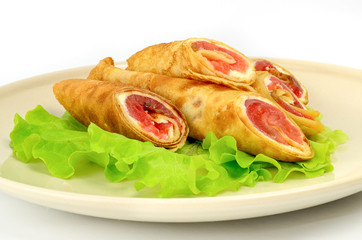 Pancakes with red fish on a piece of lettuce