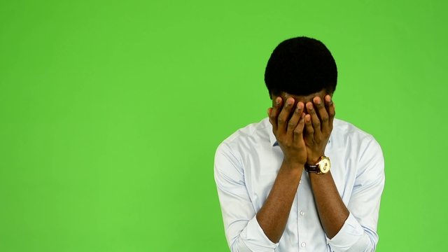 young handsome black man cries  - green screen - studio