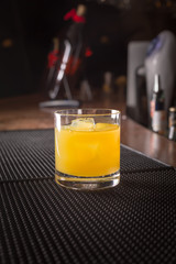 Screw driver cocktail on a bar ribber mat