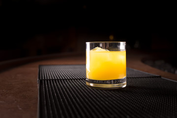 Screw driver cocktail on a bar ribber mat