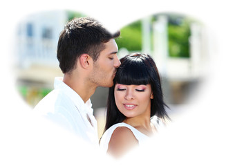 Beautiful young romantic couple and heart-shaped frame