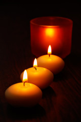Glass candlestick and candles on wooden table