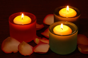 Glass candlesticks and rose petals.  Selective focus on the righ