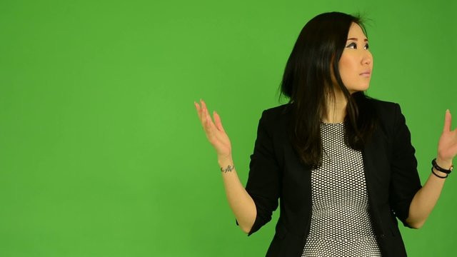 asian woman is surprised - green screen studio