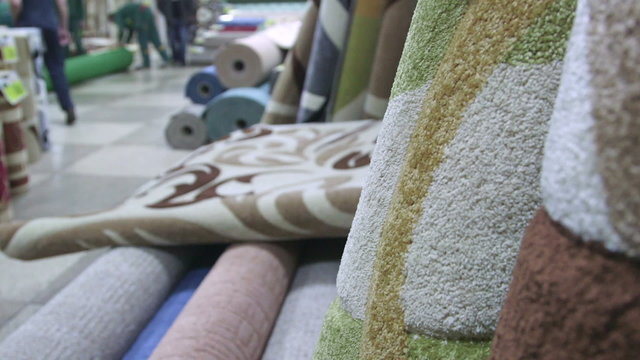 Carpets and rugs in store staff serving customers