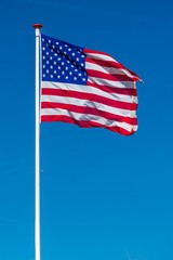 American flag on the blue sky