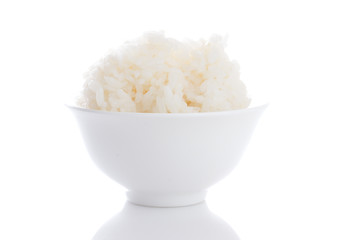 Grains of rice in a bowl isolated on white background.