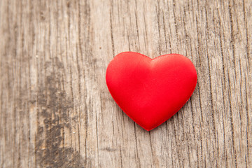 red heart over a wooden background