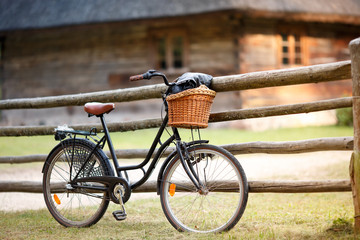 Old bicycle with basket in countryside