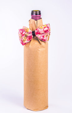 bottle wrapped in paper with decorative bow