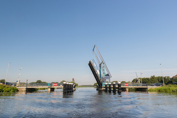 Fototapeta na wymiar Dutch river with open bridge
