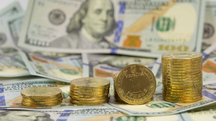 Ukrainian currency hryvnia on the background of 100 dollar bills
