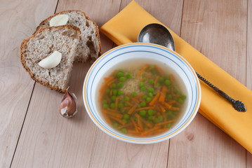 Bowl of Warm Soup with Green Peas, Carrot and Rice.