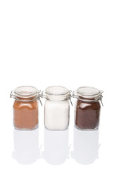 Instant coffee, chocolate drink powder and sugar in glass jar 