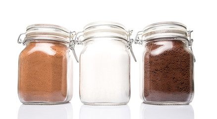 Instant coffee, chocolate drink powder and sugar in glass jar 