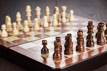 chess board with figures on wooden table