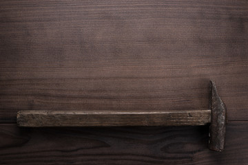old rusty hammer on wooden background