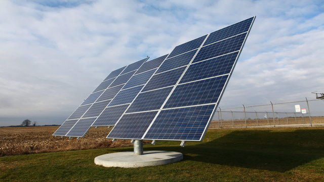 Timelapse view of a moving solar panel on a bright sunny day