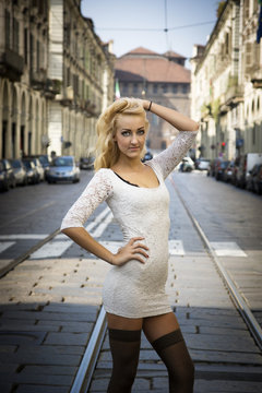 Pretty Young Woman in White Dress at the City