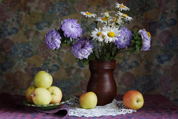 Classical still life with apples and beautiful flowers into a va