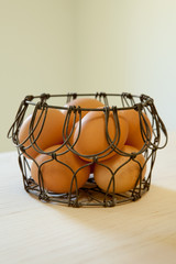 Brown eggs in a wire basket