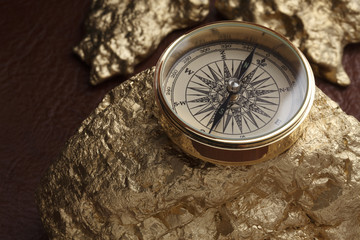 Gold nuggets and a compass