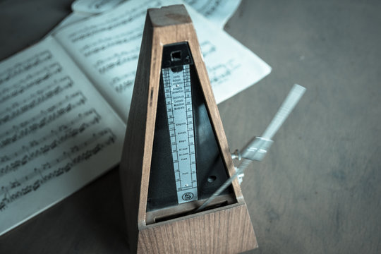 Wooden metronome sets the rhythm by swinging pendulum
