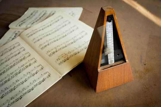 Wooden metronome sets the rhythm by swinging pendulum