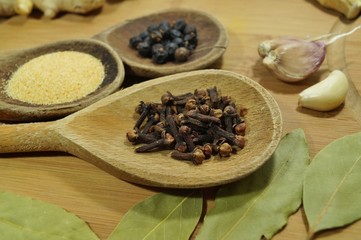 Spices and herbs on wooden spoons