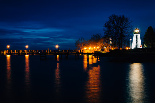 Concord Point Lighthouse and a pier at night in Havre de Grace,