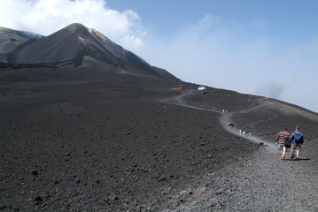 People hiking at mount Etna on the island of Sicily