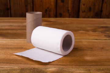 white toilet paper on a wooden table