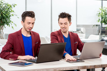 Two brothers twins working at the office