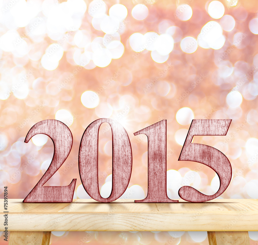 Aufkleber 2015 year number on modern wooden table with sparkling bokeh