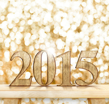 2015 year number on wooden table with sparkling bokeh