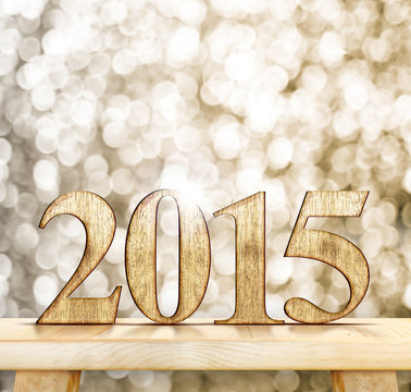 2015 year wood number on wooden table with sparkling bokeh