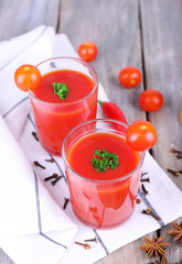 Tomato juice in glasses and fresh vegetables