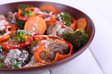 Braised wild mushrooms with vegetables and sauce in plate