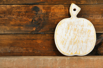 Empty cutting board on wooden background